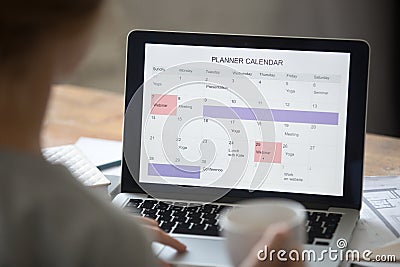 Open laptop on the desk, planner calendar on the screen Stock Photo