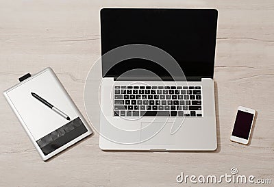 Open the laptop, graphics tablet and smart phone on a light table Stock Photo