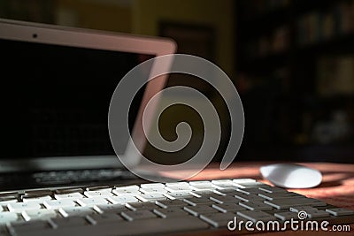 Open laptop and keyboard with mouse. Home environment Stock Photo