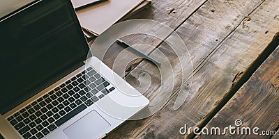 Open laptop , pencil and notebook on rough weathered wooden surface, with copy space for text. Stock Photo