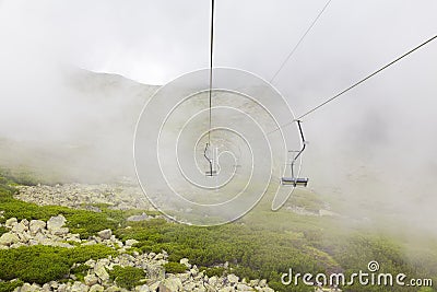 The open lift moves effortlessly through low clouds Stock Photo