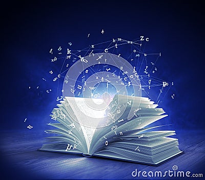 Open Magic Book with magic light and flying letters Stock Photo