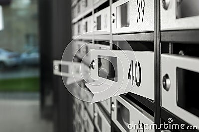 Open mailboxes with keyholes, numbers and receipts in post office, closeup Stock Photo