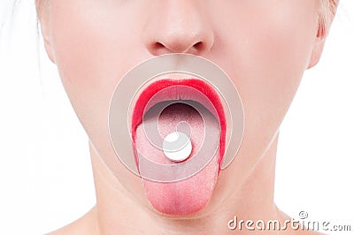 Open mouth holding medicine pill on tongue. Stock Photo