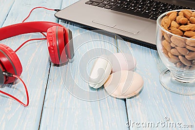 Open notebook with Cup of almonds, marshmallows and red headphones. Stock Photo