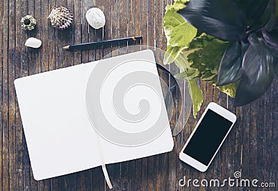 Open notebook flat lay photo. Notepad with blank page and smartphone Stock Photo