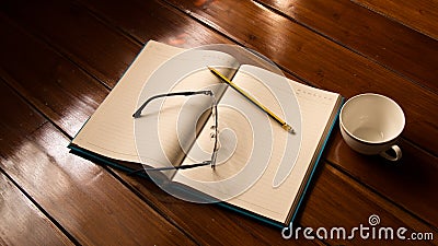 Notebook, Glasses , Pencil and Cup Stock Photo