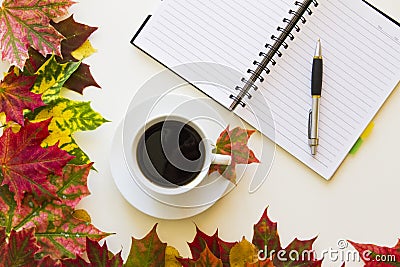 Open notebook, pen and cup of coffee, framed with autumn leaves on white background. Flat lay. Top view. Empty copy Stock Photo