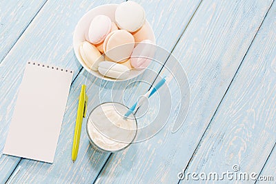 Open notebook, white mug with coffee, marshmallows. Stock Photo