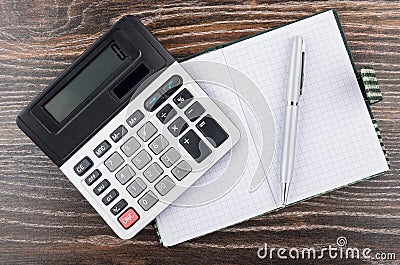 Open notepad, ballpoint pen and electronic calculator on table Stock Photo