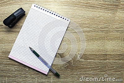 Open notepad for writing fountain pen and stapler on the table copy space Stock Photo