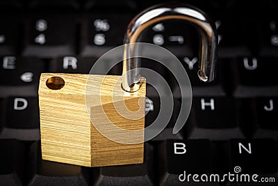 Open padlock on a black computer keyboard Stock Photo