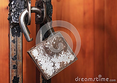 Open padlock hanging on a metal grille. Open access concept, login options. Copy space Stock Photo