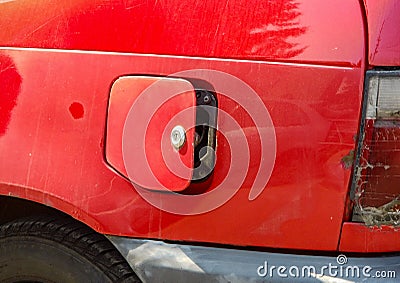 Open petrol cap on an old red car after successful theft of a gasoline or diesel fuel Stock Photo