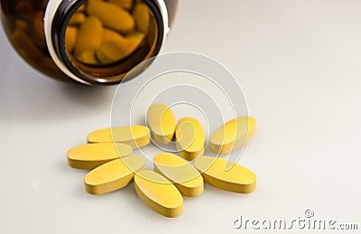 Open pill bottle with medicine spilling out Stock Photo