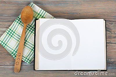 Open recipe book on wooden background. Stock Photo