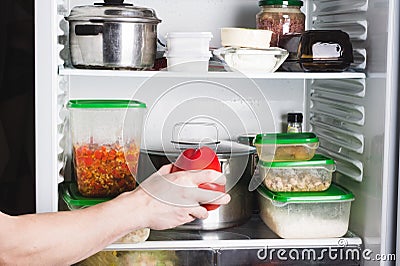 Open refrigerator with food in kitchen. Stocks of food for next mealtime Stock Photo