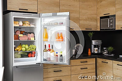Open refrigerator full of products Stock Photo