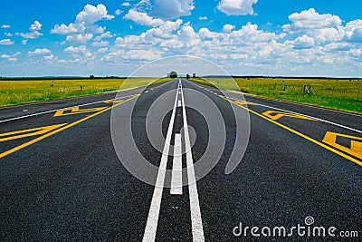 Open road beneath a brilliant blue African sky Stock Photo