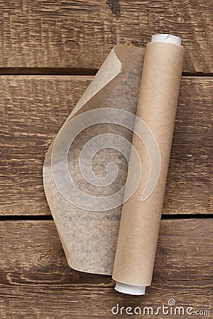 An open roll of paper on the wooden table background Stock Photo