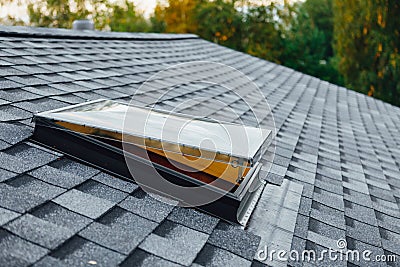 Open roof window on shingles flat polymeric roof-tiles Stock Photo