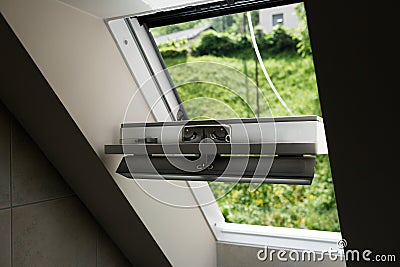 Open roof window, skylight with beautiful view. Plastic mansard on attic with environmentally friendly and energy Stock Photo