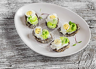 Open sandwiches with cream cheese, quail eggs and celery. Delicious healthy Easter snack Stock Photo