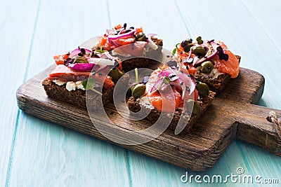 Open sandwiches with salmon, capers, soft cheese , red onions close up Stock Photo