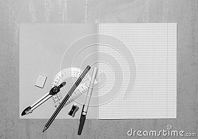 Open school notebook mock up with copy space, ballpoint pen, pencil, eraser, compasses, steel protractor and pencil sharpener top Stock Photo