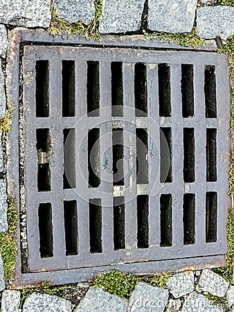 Open sewer manhole on an old paved road.Top view Stock Photo