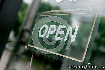 Open sign in street cafe business sign shot through a diner window Stock Photo