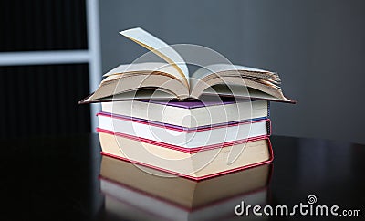 Open stack hardback books on wooden table. Education background Stock Photo