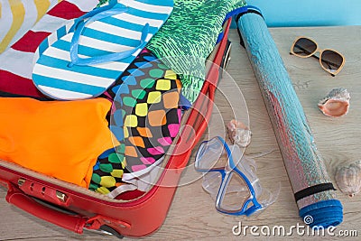 Open suitcase with different things. Travel concept. Open traveler& x27;s bag with clothing, accessories Stock Photo