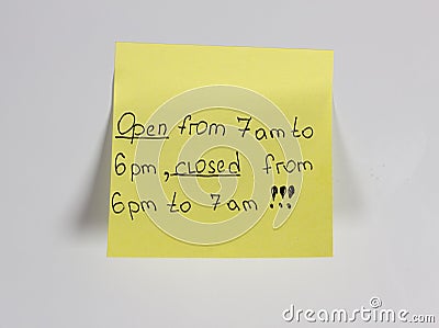 Open from 7 am to 6 pm, closed from 6 pm to 7 am,yellow sticker on the door fridge magnet Stock Photo
