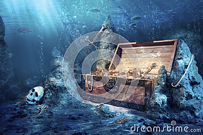 Open treasure chest with bright gold underwater Stock Photo