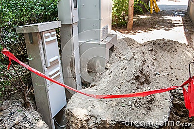 Open trench for new underground electric cables with transformer replacement on the street for house electricity system, selective Stock Photo