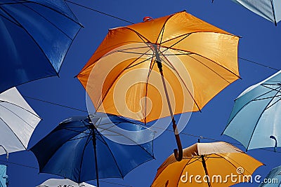 Open umbrellas as a sun canopy on a city street on a clear sunny day Editorial Stock Photo
