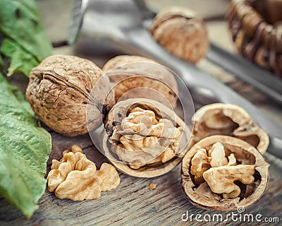 Open walnut close up, nutcracker and basket on background Stock Photo