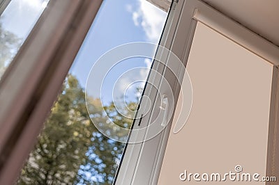 open white pvc plastic window. Airing the room on a fine summer day Stock Photo