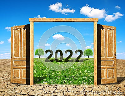 Open wooden door to the beautiful spring landscape with number 2022. Concept of Happy New Year. Stock Photo