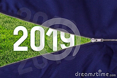 Open zipper on fresh green grass background with 2019 text. Stock Photo