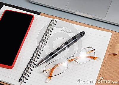 Opened agenda with handwritten MONDAY on a grey close up Stock Photo