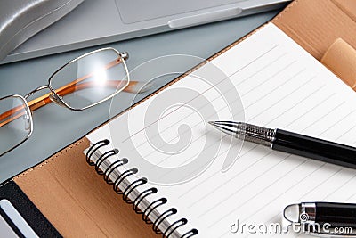 Opened agenda and pen on a grey close up Stock Photo