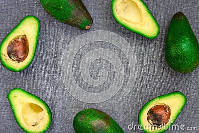 Opened avocado showing seed on textured grey linel background. Top view, Copy space Stock Photo