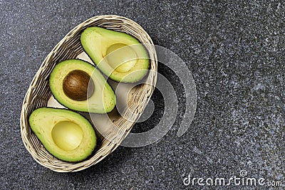 Opened avocado showing seed on textured stone background Stock Photo