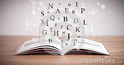 Opened book with flying letters Stock Photo