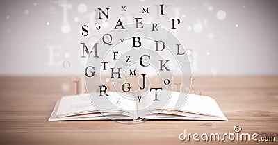 Opened book with flying letters Stock Photo