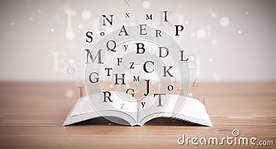 Opened book with flying letters Stock Photo