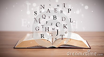 Opened book with flying letters Stock Photo