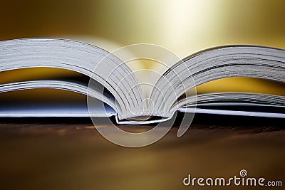 Opened book on a golden background. Close-up Stock Photo